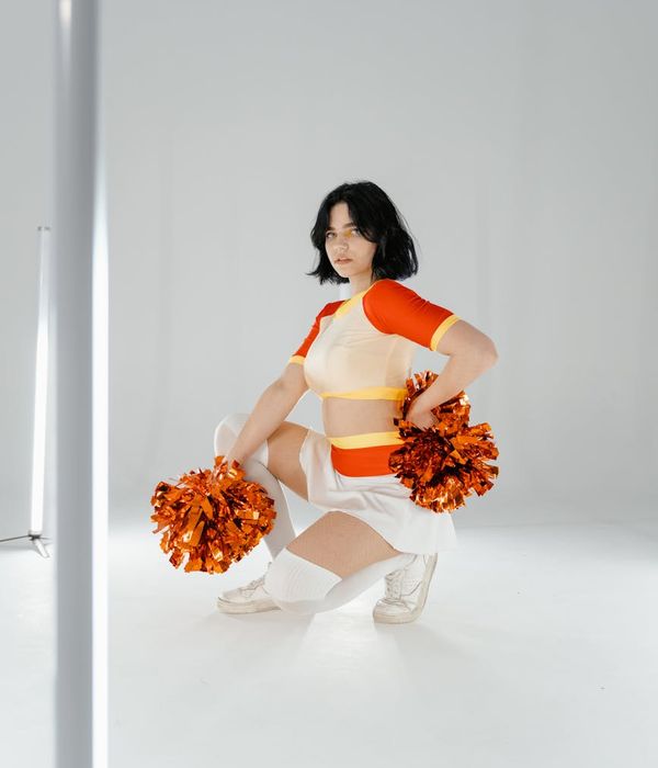 Athletic man performing a dynamic strength exercise in a bright studio.