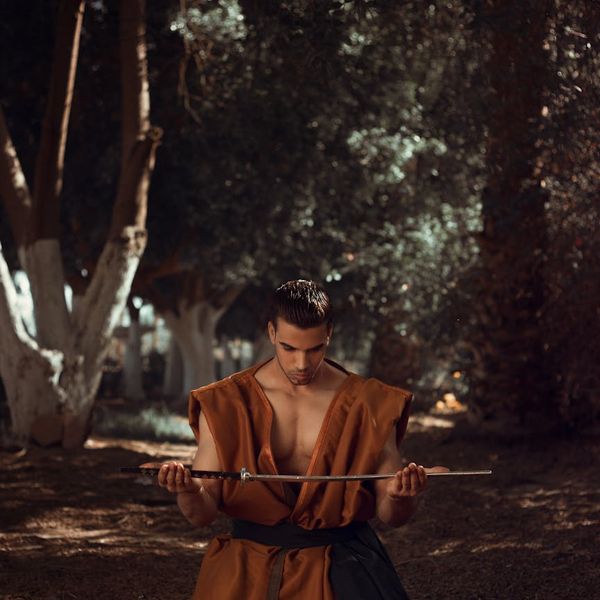 Man in a meditative pose after a workout, looking calm and focused.